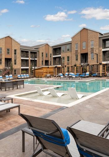 Resort-style swimming pool with cabanas & sun shelf