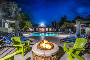 Phoenix apartment for rent - a fire pit and pool at night at the resort at turf