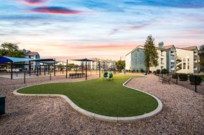 Phoenix apartment for rent - a park with a playground and buildings at sunset at Array South Mountain, Phoenix, AZ, 85044