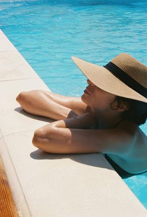 Aurora apartment for rent - A person in a hat is sitting by a pool.