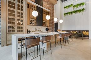 Dallas apartment for rent - a kitchen with a long counter and chairs in a restaurant