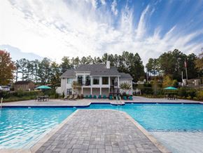 Marietta apartment for rent - High-End Apartments in Marietta, GA - The Grandstand - A Swimming Pool With A Paver Walkway Leading To Lounge Chairs, Umbrellas, And A Clubhouse.