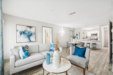 Jacksonville apartment for rent - A living room with a white couch and a blue pillow.