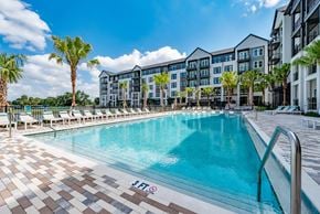 Tampa apartment for rent - Community swimming pool and apartment side views at The Brooke at Rocky Point in Tampa, Florida.