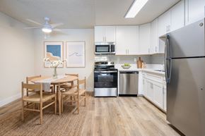 San Diego apartment for rent - A kitchen with a table and chairs and a fridge.
