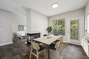 Lawrenceville apartment for rent - a dining area with a wooden table and chairs and a fireplace in the background