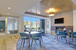 Watertown apartment for rent - A modern dining room with a wooden ceiling and a fireplace.