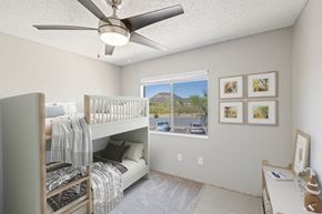 Tucson apartment for rent - Model apartment bedroom with a bunk bed and a ceiling fan