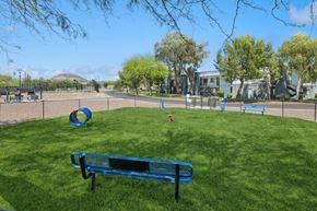 Tucson apartment for rent - a park bench sitting in the grass near a playground