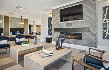 Clubroom featuring large tv, games, poker table, community fireplace, & plenty of banquette seating for gatherings & events