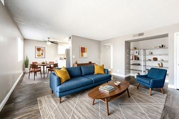 Las Vegas apartment for rent - A living room with a blue couch and a coffee table.