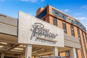 Aurora apartment for rent - The Parker at Mike's Station building has a large sign on the front.