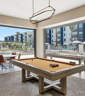 Game room with lounge seating, tvs, shuffleboard, & billiards table