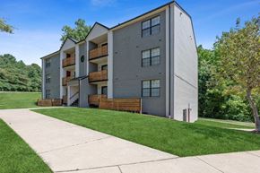 Dale City apartment for rent - Apartment building exterior with lush greenery