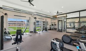 Glendale apartment for rent - Westgate, AZ, Pet-Friendly Apartments - Glen 91 - A Modern Fitness Center Features Cardio Machines, Weight Equipment, Large Windows, Exposed Ductwork, And Ceiling Fans.