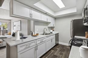 Las Vegas apartment for rent - a kitchen with white cabinets and stainless steel appliances