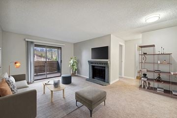Renton apartment for rent - a living room with a fireplace and a television