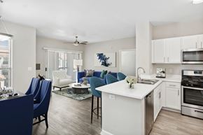 North Las Vegas apartment for rent - A modern kitchen with blue chairs and white cabinets.