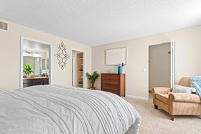 Lakewood apartment for rent - A bedroom with a large bed and a couch.