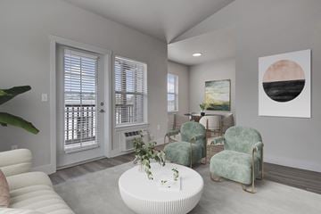 Tualatin apartment for rent - A living room with a white couch, a green chair, and a painting on the wall.