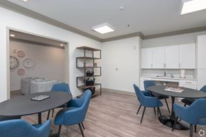 Conyers apartment for rent - A dining room with a round table and blue chairs.