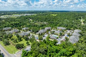 Dade City apartment for rent - A bird's eye view of a residential area with houses surrounded by greenery.