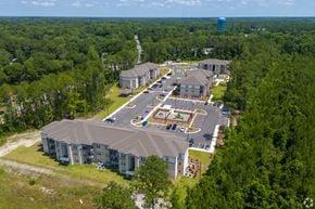 Kingsland apartment for rent - An aerial view of a large building surrounded by trees. at Arbours at Kingsland, Kingsland, 31548