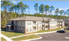 Satsuma apartment for rent - A large building with a parking lot in front of it at Arbours at Satsuma Apartments, Mobile