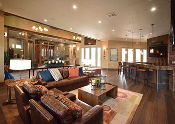 Ocoee apartment for rent - A living room with brown leather couches and a coffee table.