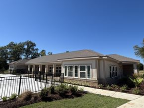 Lake Charles apartment for rent - A house with a black fence in front of it at Arbours at Lake Charles, Lake Charles, 70605 