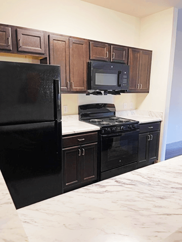 Covington apartment for rent - a kitchen with black appliances and white counter tops