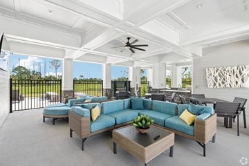 Cocoa apartment for rent - A spacious outdoor living room with a sofa set and a ceiling fan.