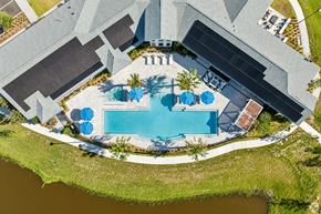 Cocoa apartment for rent - An aerial view of a house with a pool and a patio area.