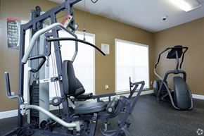 Montgomery apartment for rent - A gym with a weight machine and a bench.