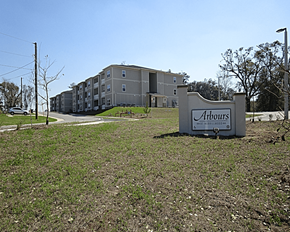Alachua apartment for rent - A sign for Arbours is in front of a building.