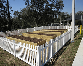 Alachua apartment for rent - A white picket fence with brown boards on top.