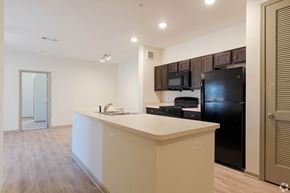 Villa Rica apartment for rent - A kitchen with black appliances and a white countertop. at Arbours at Villa Rica, LLC, Villa Rica, GA, 30180