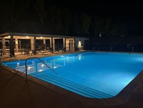Covington apartment for rent - A swimming pool at night with lights on.