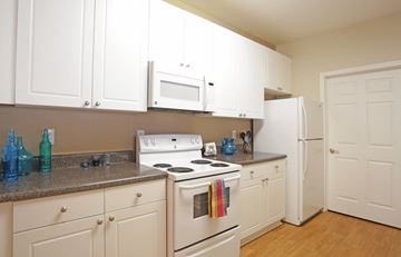 Montgomery apartment for rent - A kitchen with white cabinets and appliances.