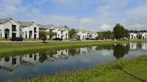 Montgomery apartment for rent - A row of houses are reflected in the water.