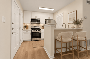Fairfax apartment for rent - Modern kitchen with breakfast bar and upholstered stools at The Courts at Fair Oaks Apartments, Fairfax, VA 22030