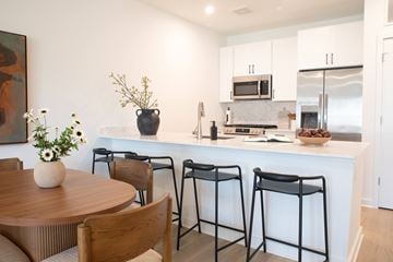 Colts Neck apartment for rent - A kitchen with a table and chairs in front of it.