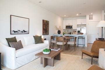 Colts Neck apartment for rent - A living room with a white couch and a painting on the wall.