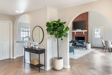 Ridgeland apartment for rent - A living room with a brick fireplace and a television above it.