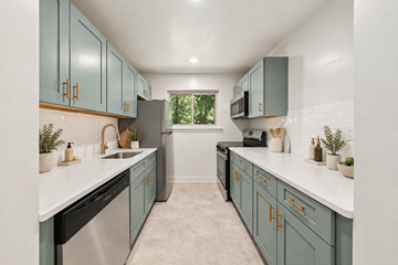 Atlantic Highlands apartment for rent - A kitchen with teal cabinets and white countertops.