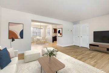 Chatham apartment for rent - A living room with a white couch, a coffee table, and a painting on the wall.
