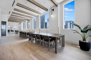 Miami apartment for rent - a large dining room with a long wooden table and chairs