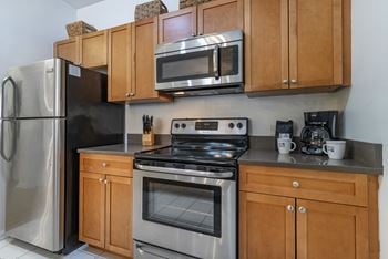 Kitchen with stainless appliances and gray countertops