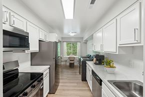 Rosedale apartment for rent - A modern kitchen with white cabinets and stainless steel appliances.