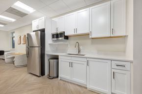 Pikesville apartment for rent - a kitchen with white cabinets and a stainless steel refrigerator at Copper and Quarry Village, Pikesville, MD, 21209